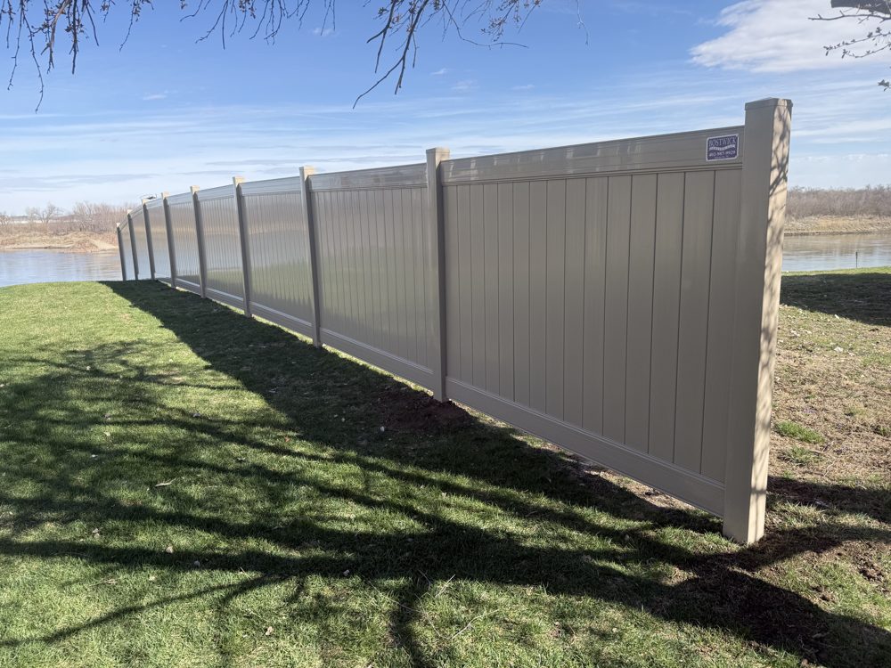 Wood privacy fence installed along a back yard