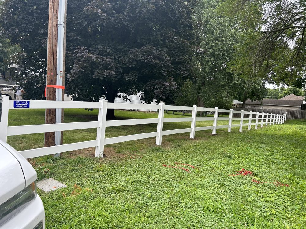 Vinyl privacy fence installed along a new build lot