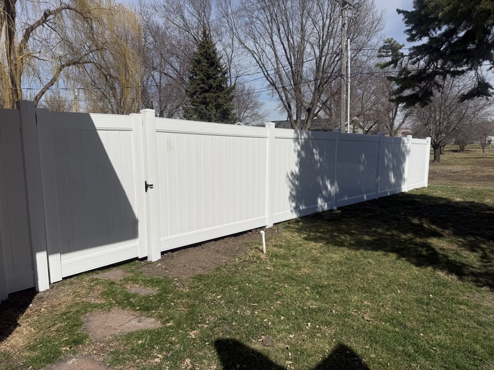 Black aluminum fence installed around a residential back yard