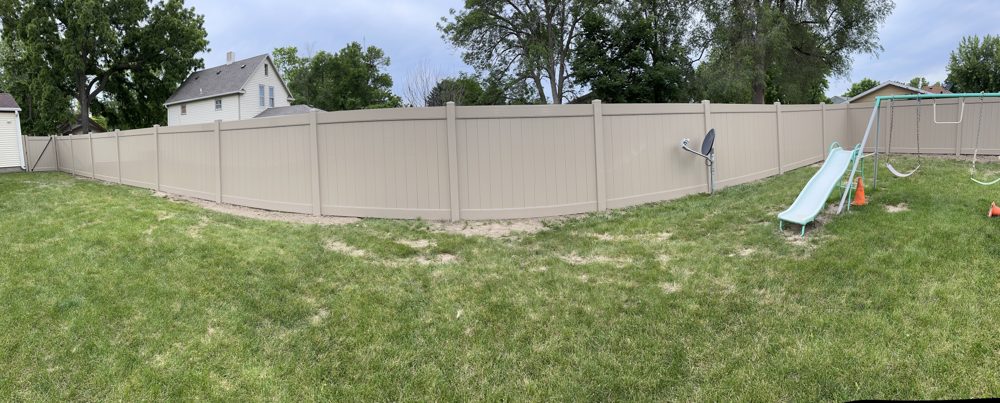 Black ornamental aluminum fence installed along a residential yard