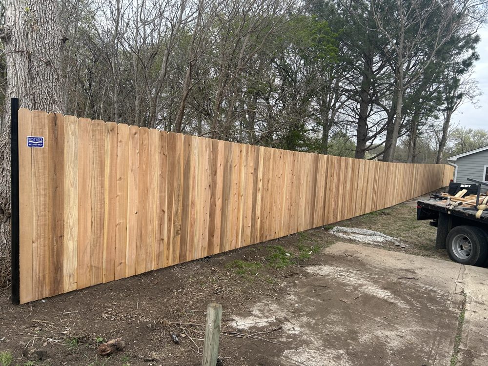 White vinyl privacy fence with gate installed at a home