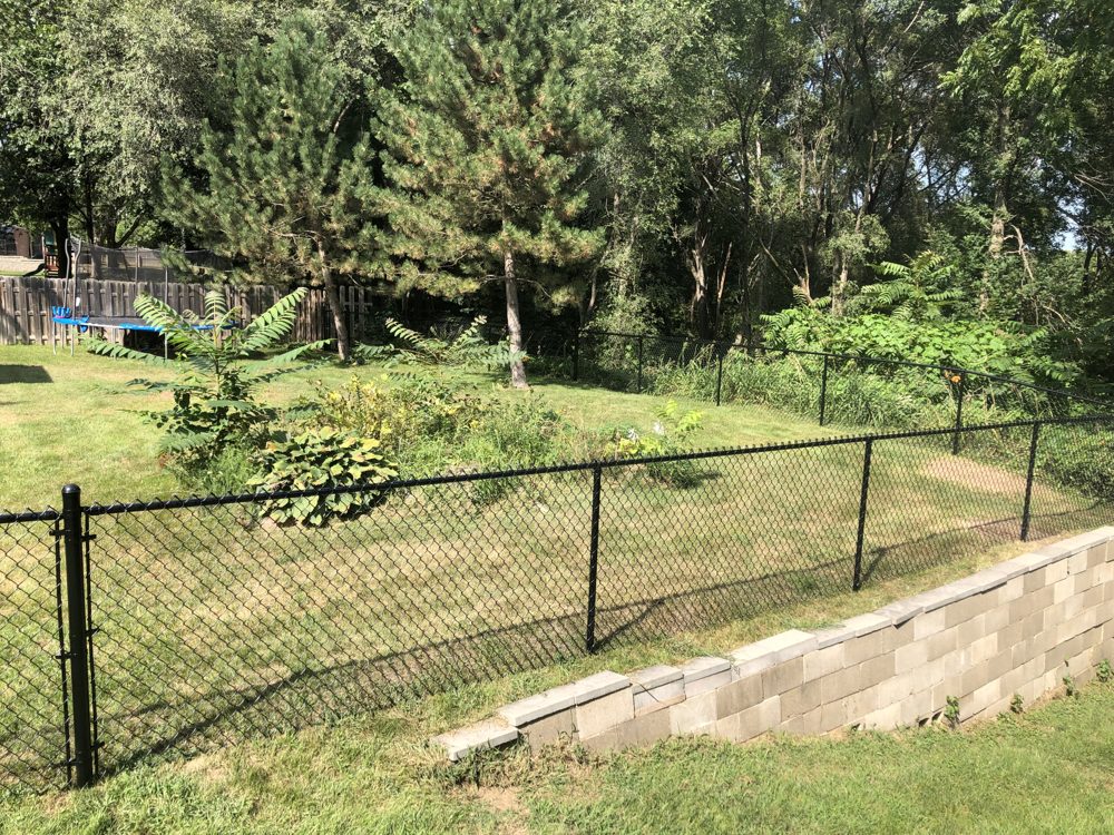 White rail fence installed along a rural property