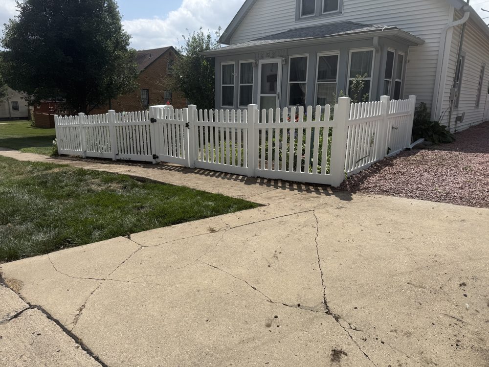 White vinyl fence installed along a residential lot line