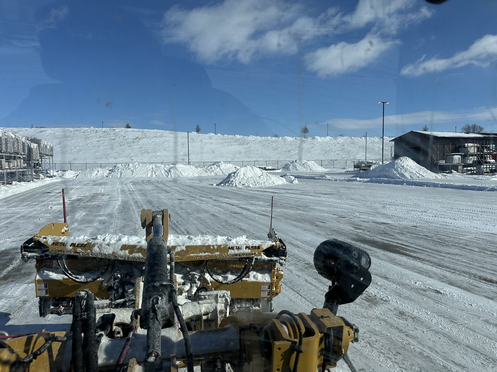 Snow removal crew clearing a commercial property in Siouxland