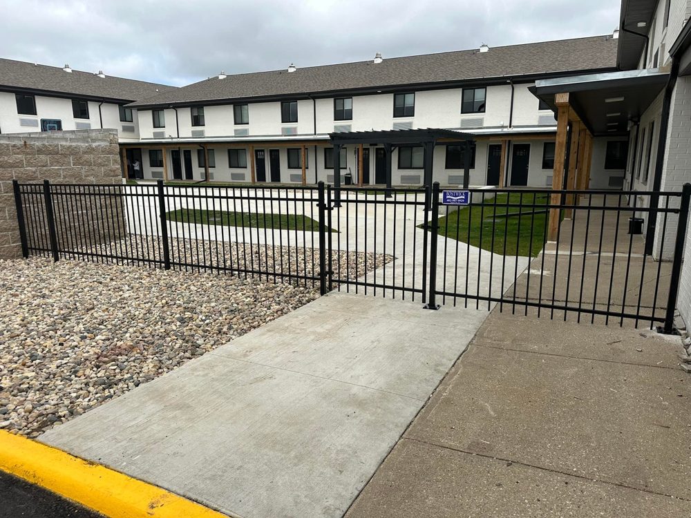 Ornamental iron fence installed in front of a commercial building