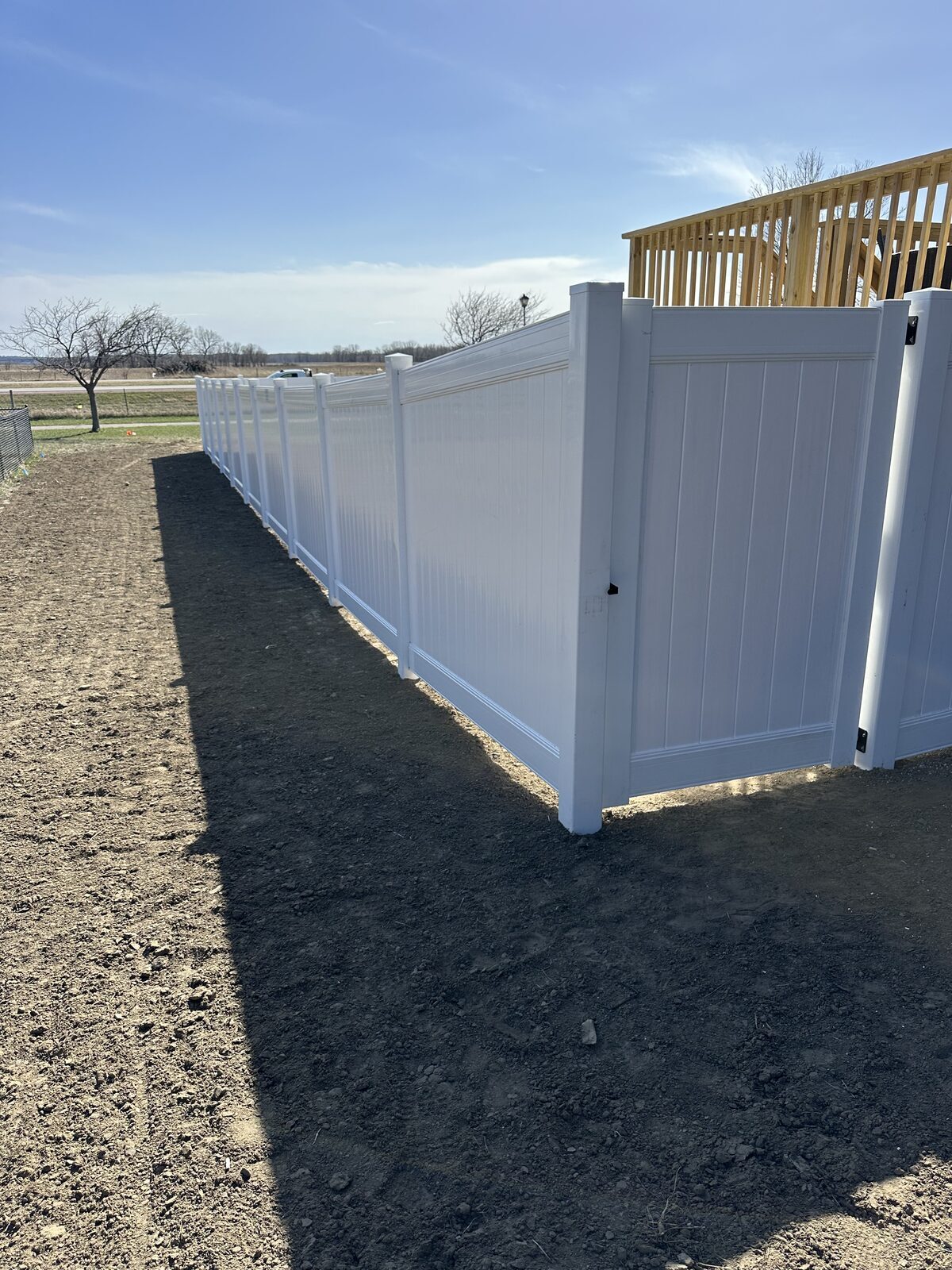 6 foot white vinyl fence installed by Bostwick Fencing & Iron