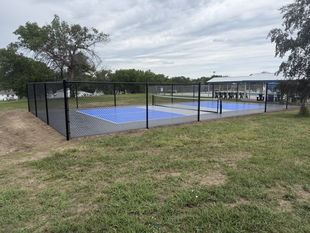 Vinyl privacy fence panels installed along a property line