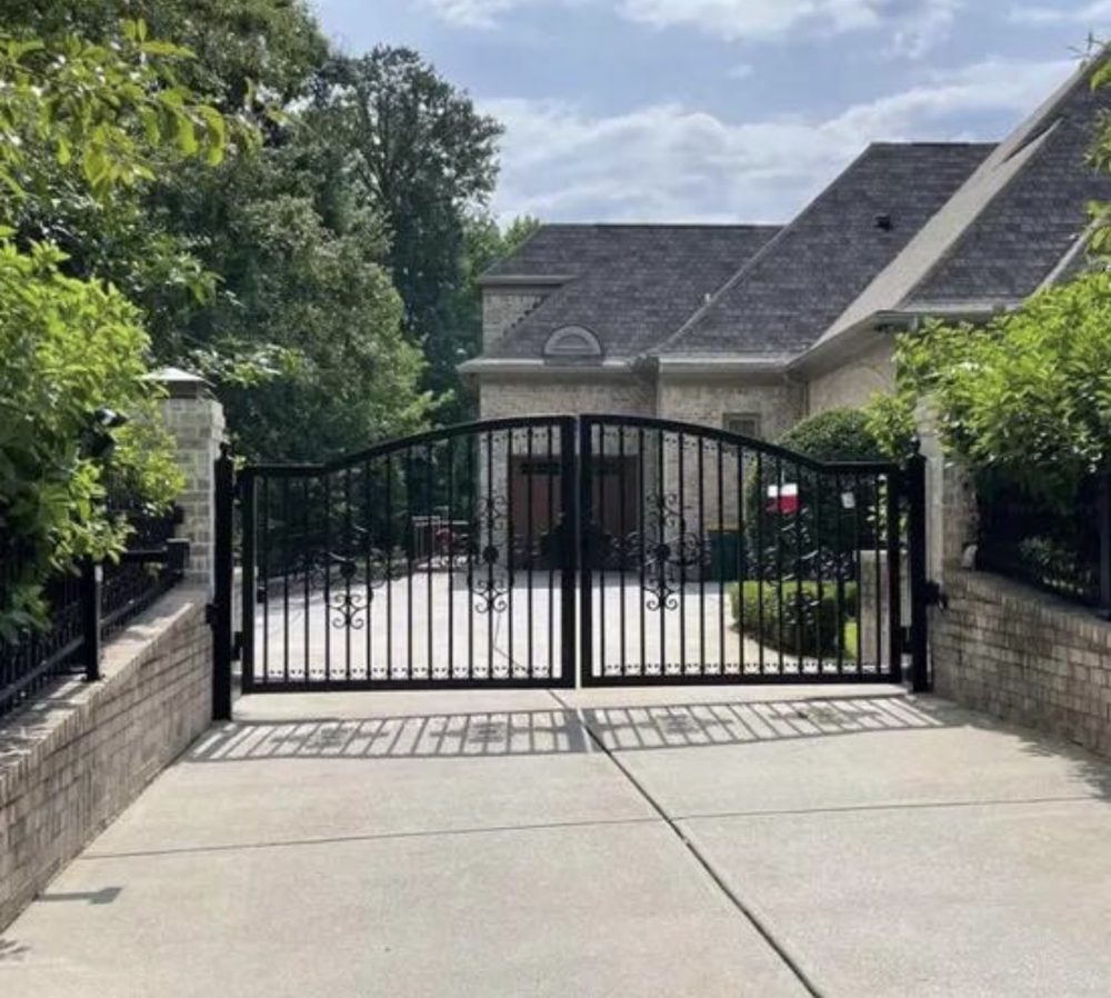 Custom ornamental iron driveway gate installed at a residence