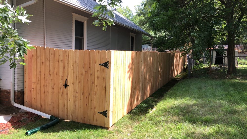Cedar wood privacy fence installed around a back yard