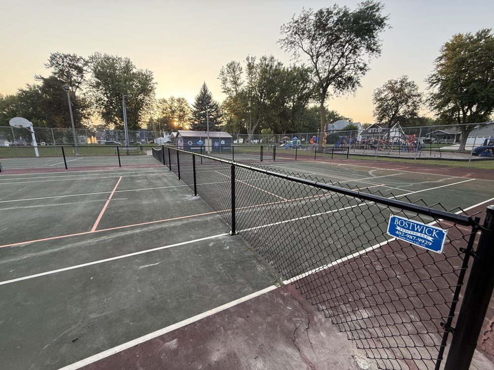 Chain link fence installed around a tennis and pickleball court