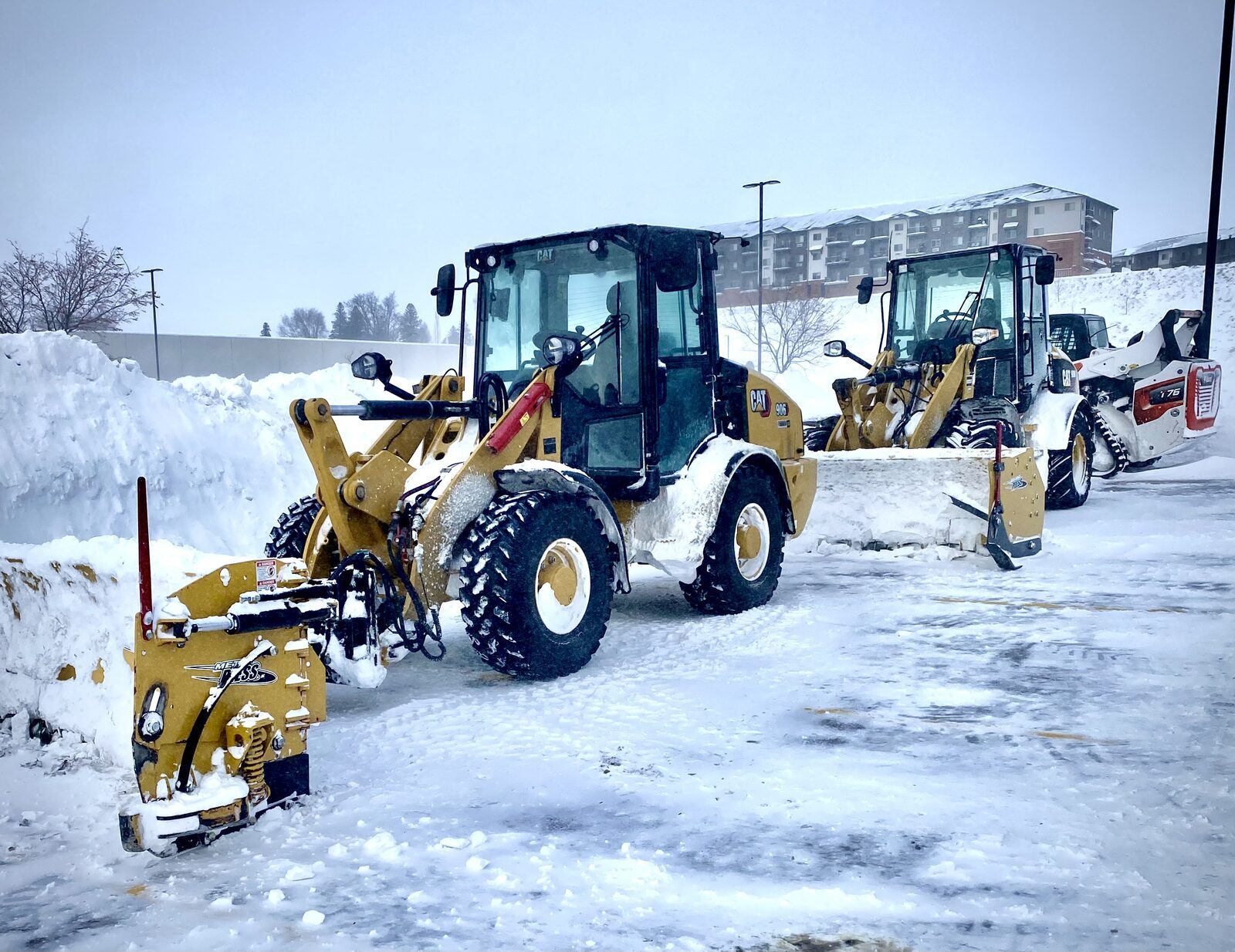 Commercial snow removal equipment clearing a lot for a Siouxland business