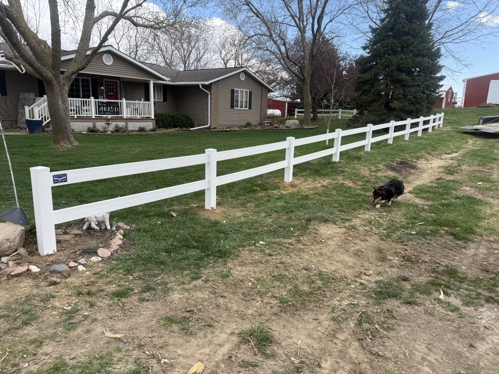 White vinyl privacy fence installed in a back yard