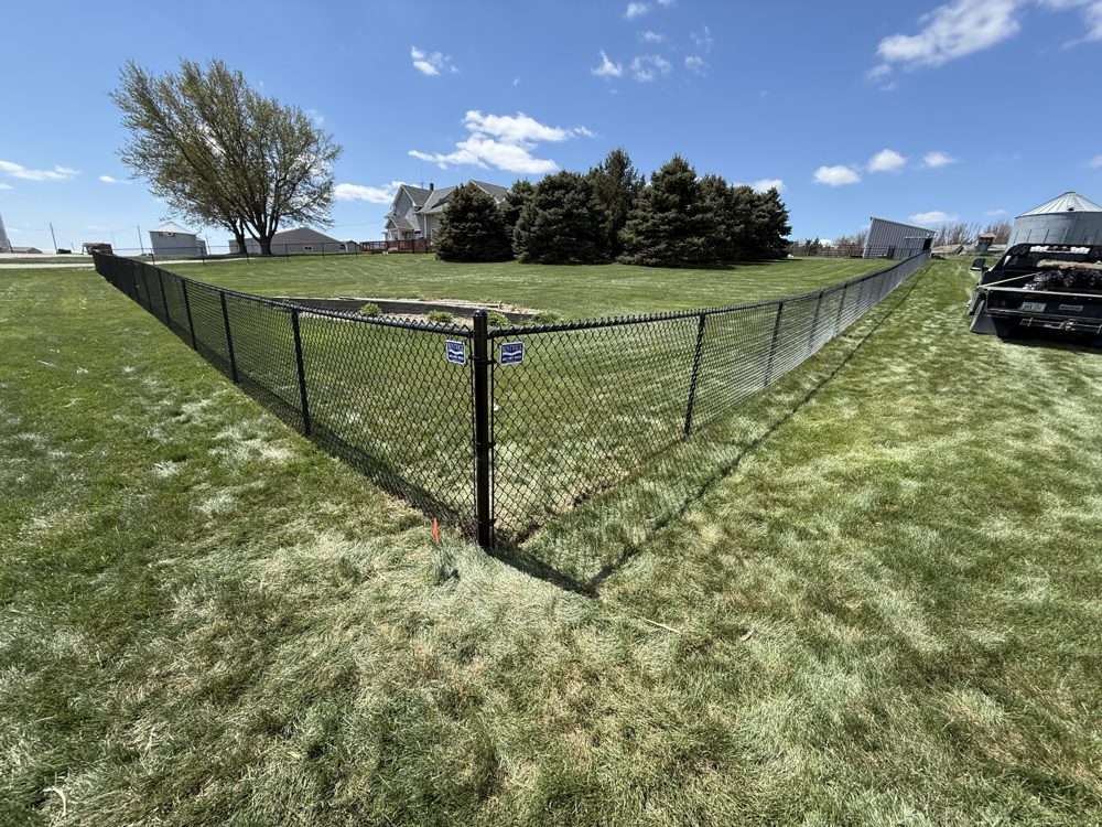 Chain link fence installed around a residential yard